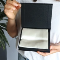 lady opens packaging with Lumieré silk pillow case
